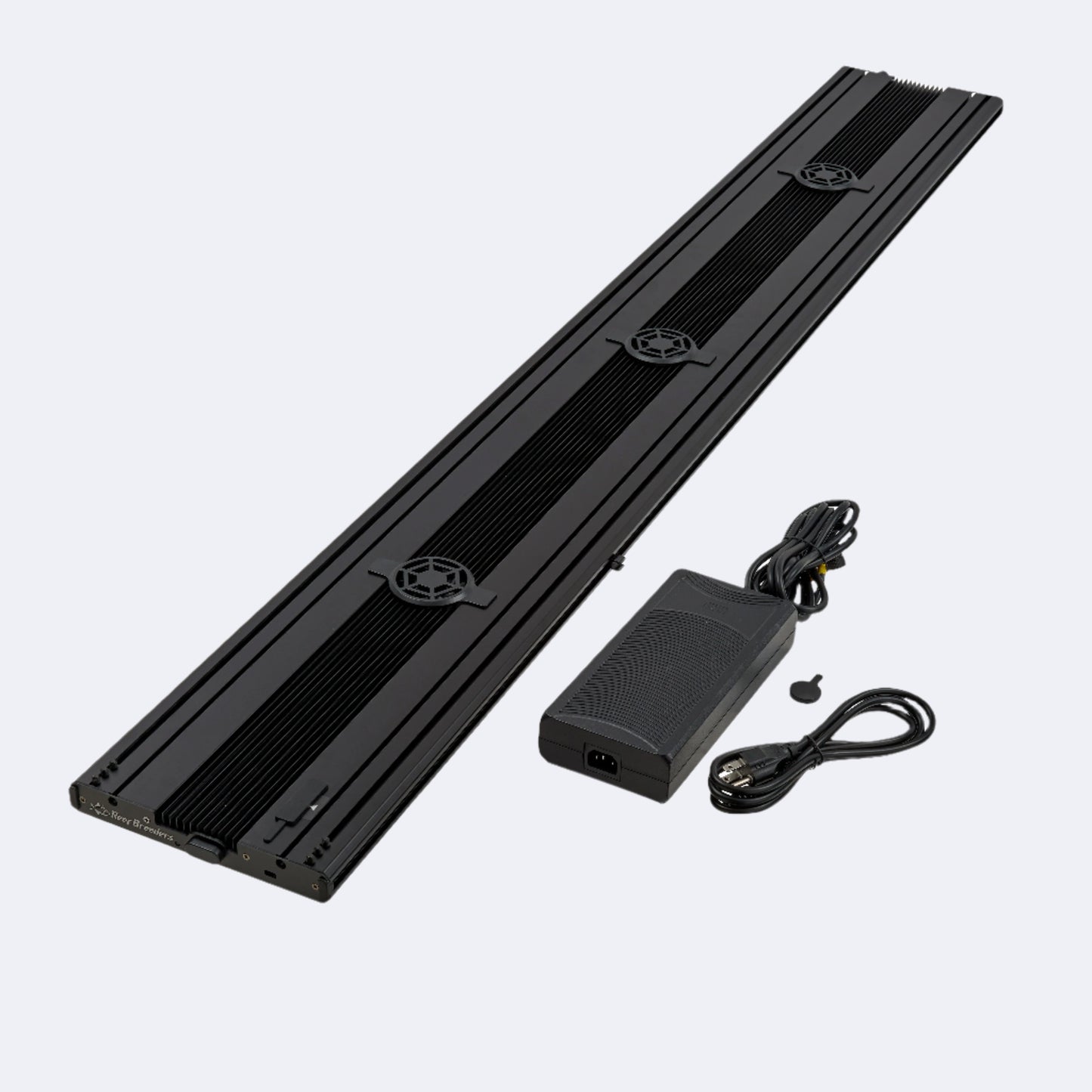 Meridian 63 top of black aluminum case pictured with AC/DC converter and plug to the right of the light.