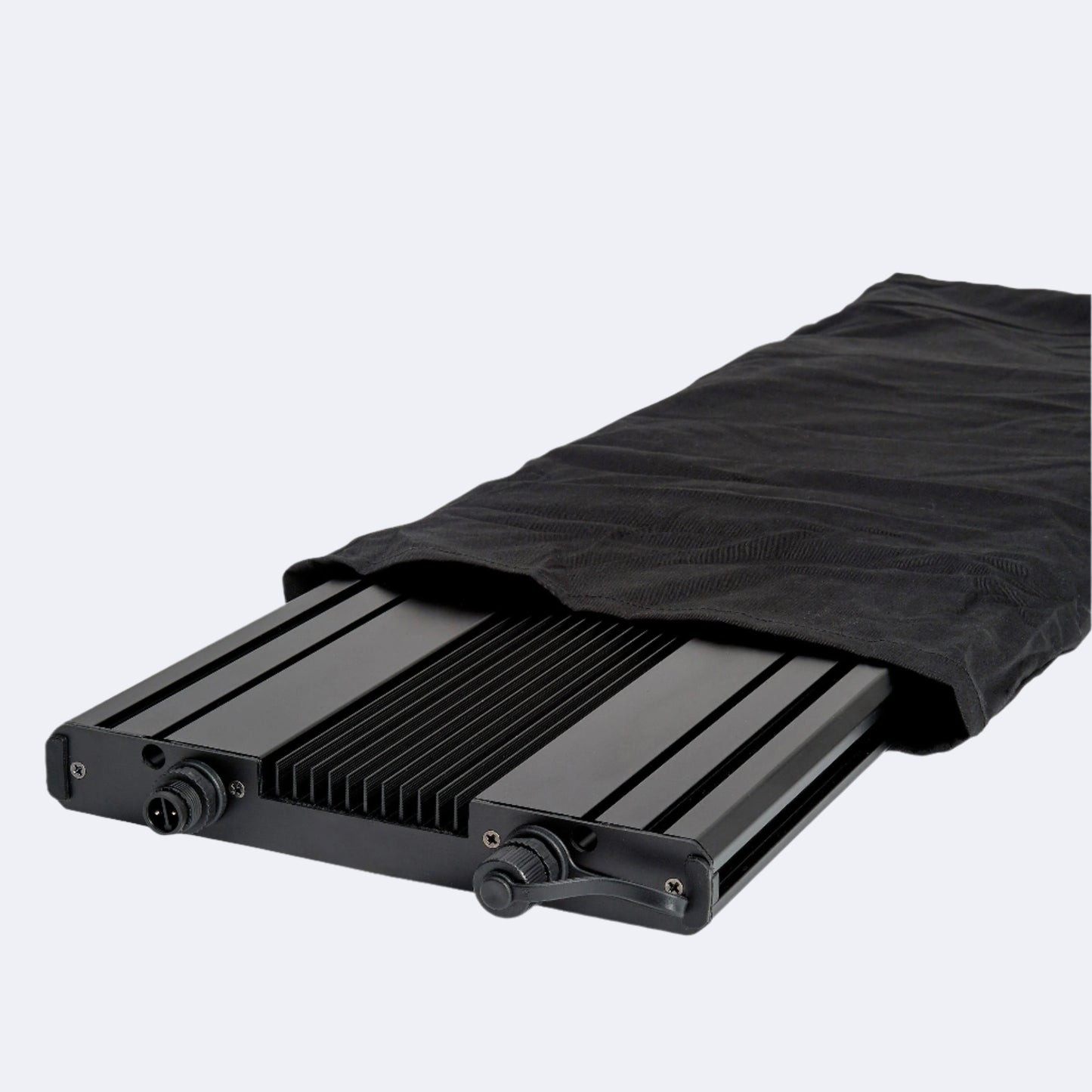 Meridian partially covered by black cotton sleeve used in packaging. Pictured with light facing downwards, showing part of the top of the heatsink.