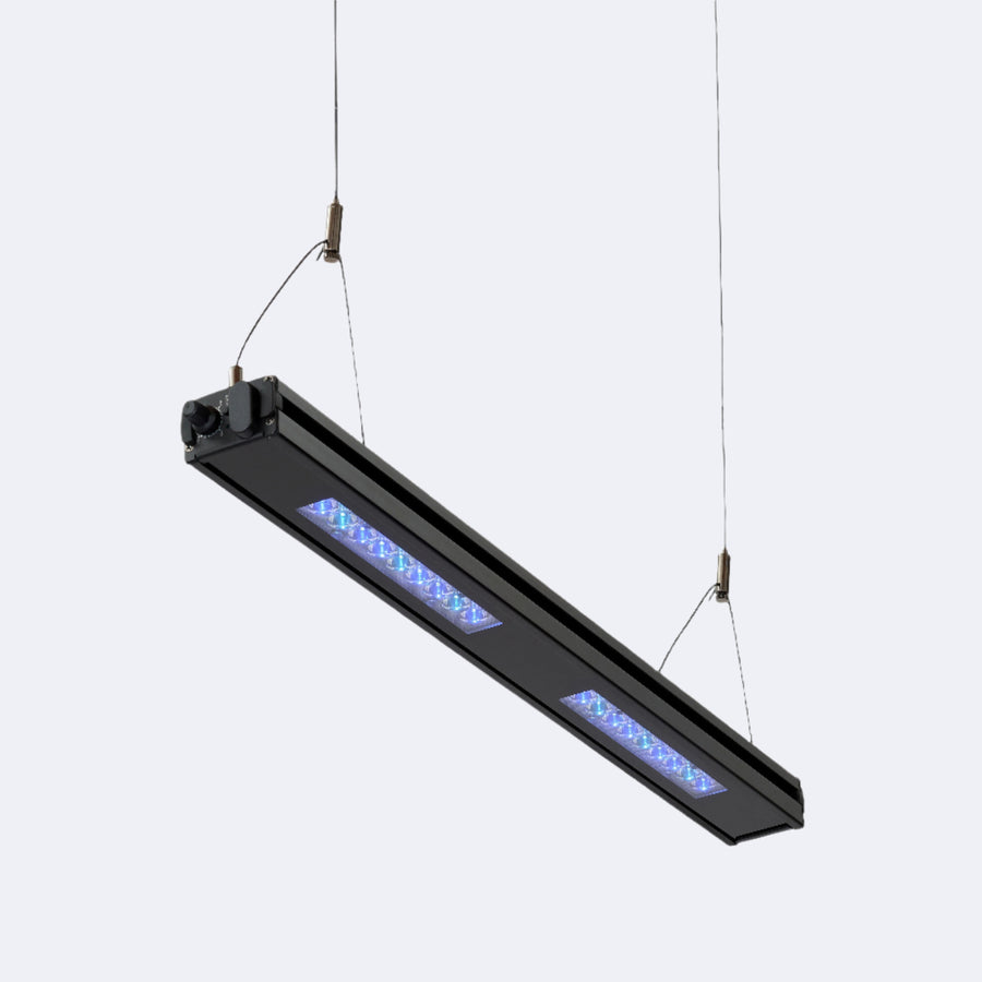 An Edge 24 bar suspended on hanging wires above a reef aquarium.